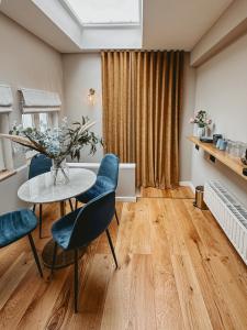 a dining room with a table and blue chairs at Maas Suites (Maastricht - Lanaken) in Lanaken