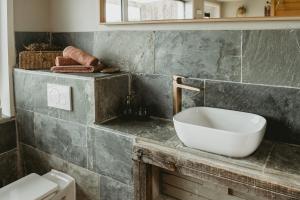 拉納肯的住宿－Maas Suites (Maastricht - Lanaken)，台面上带白色水槽的浴室