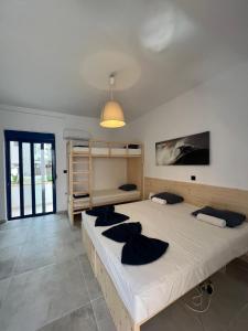 a bedroom with two beds and a light fixture at Ocean Palace in Prasonisi