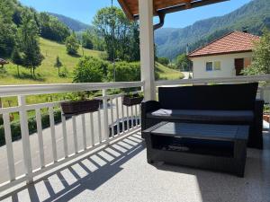 a chair on a porch with a view of a mountain at House in beautiful nature in Pazarić