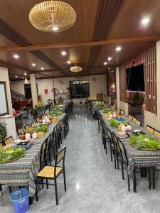 a banquet hall with long tables filled with food at Mộc Homestay in Mộc Châu