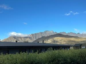a building with mountains in the background at Home Away from Home in Queenstown