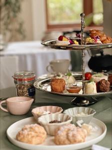 a table topped with plates of food on a tray at Sonnekus Boutique Hotel & Bistro in St James