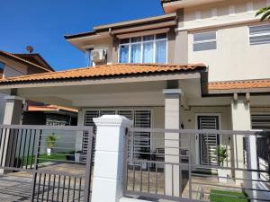 a house with a gate in front of it at Ana Homestay D'Airport in Melaka