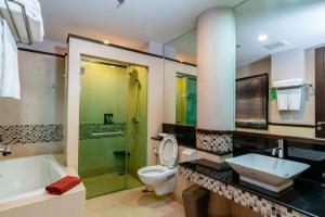 a bathroom with a sink and a toilet and a shower at Tara Mantra Cha-Am Resort in Cha Am