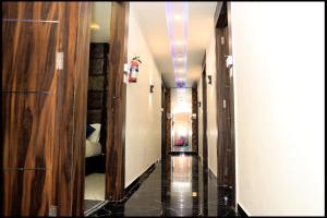 a hallway of a hotel with a long corridor at Hotel Nest pride in Ahmedabad