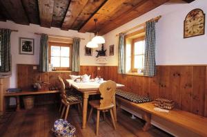 a dining room with a wooden table and chairs at Kinder-Bauernhof Ederbauer in Flachau