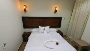 a bedroom with a large white bed with a snake on it at WWassim hotel in Cairo