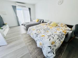 a bedroom with a bed and a couch at Modern Pod in the heart of Woden Valley in Lyons