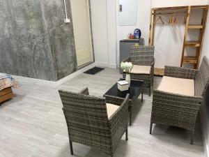 a room with chairs and a table with flowers on it at Colibri Inn in Thong Sala