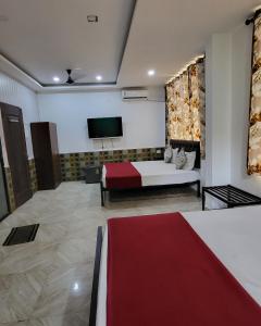 a hotel room with a bed and a tv at Hotel heaven by sky in Calangute