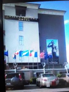 a large building with cars parked in front of it at Villa toscana Victoria island oniru in Lagos