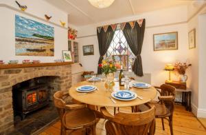 a dining room with a table and a fireplace at The Cherries in York +30 photos