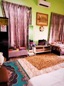 a living room with purple curtains and a rug at DYANA INN TRANSIT ROOMS in Kota Bharu