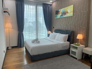 a bedroom with a bed and a large window at Opus Residence 118 tower view by Square in Kuala Lumpur