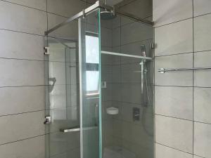 a shower with a glass door in a bathroom at Opus Residence 118 tower view by Square in Kuala Lumpur