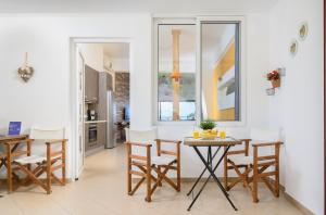 a kitchen and dining room with a table and chairs at More Crete Village House Koutouloufari in Hersonissos