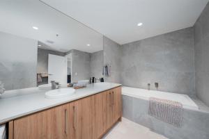 e bagno con vasca, lavandino, vasca e vasca. di Park View Paradise a Adelaide Altre 37 foto