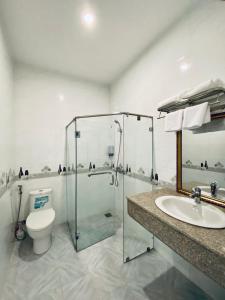 a bathroom with a shower and a toilet and a sink at Miền Tây Hotel in Can Tho