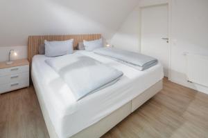 Postel nebo postele na pokoji v ubytování Haus an den Dünen