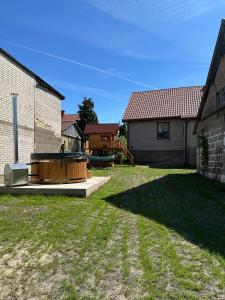 a backyard with a hot tub and a house at Krok od Biebrzy in Dolistowo Stare