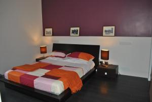 a bedroom with a large bed with two lamps at La Terrazza dell’ODEON in Catania