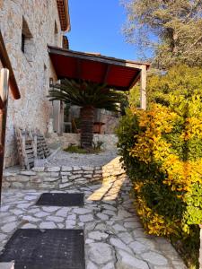 a stone walkway in front of a building with a red roof at Chambre d'hôtes Le Clos 67 in Saint-Paul-de-Vence