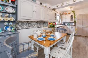 a kitchen with a wooden table and chairs at The Cherries in York