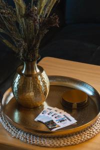 a plate with a vase on a table with plates at Sękata Chata in Szaflary