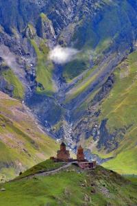 a painting of a building on top of a mountain at Crystal Kazbegi in Stepantsminda