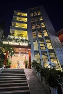 a tall building with stairs in front of it at Hotel- The Yellow Queen in Guwahati