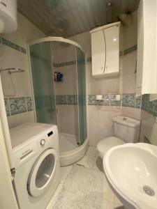 a bathroom with a shower and a toilet and a sink at Apartman Skadarlija in Belgrade +9 photos