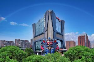 Hampton by Hilton Wuhan Zhongnan Jiedaokou Hotel في ووهان: مبنى كبير امامه تمثال