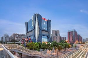 a tall building in the middle of a city at Hampton by Hilton Wuhan Zhongnan Jiedaokou Hotel in Wuhan