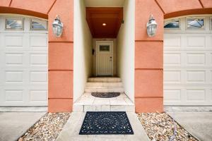 a pair of white garage doors on a house at Be A Nomad - 1 blk to beach - Stylish studio in Jacksonville Beach