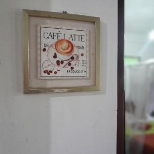 a picture of a cup of coffee on a wall at Silver Dome Guest House in Ella