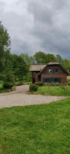 a house sitting on top of a green field at Chaumière d'Albâtre - Gîte-Entre terre et Mer in Ourville-en-Caux