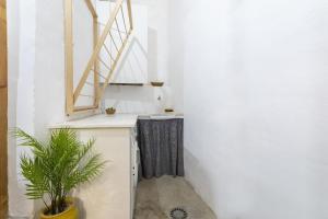 a hallway with a window and a potted plant at Casc Antic in Jávea