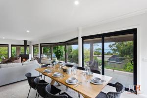 a dining table and chairs in a living room at Spacious Retreat with Coastal Views in Cowes