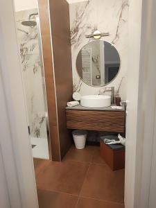 a bathroom with a sink and a mirror at Le Suite di Magda Relax & Rooms in Polignano a Mare