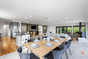 a dining room and living room with a table and chairs at Spacious Retreat with Coastal Views in Cowes