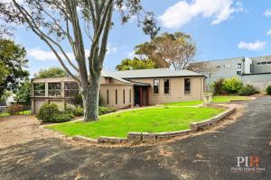 a house with a tree in front of it at Spacious Retreat with Coastal Views in Cowes