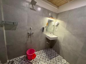 a bathroom with a sink and a toilet in it at Candolim beach touch flats in Candolim