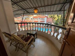 a balcony with chairs and a table and a view at Candolim beach touch flats in Candolim