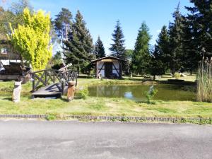 un parco con laghetto e gazebo di Pension Haus zum See a Markische Heide