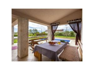 a table and some chairs on a patio at Villa van steen Mirela in Barban