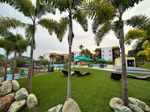 a park with palm trees and a swimming pool at Apartasol 102c Tebaida Quindio in La Tebaida +20 photos