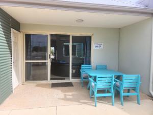 a blue table and chairs on a patio at Unit 34 Seafront Estate in Jurien Bay
