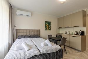 a bedroom with a large bed with two pillows at Studios in Sveta Elena complex with mineral pool in St. St. Constantine and Helena