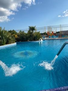 a swimming pool with a hose in the water at Mobil Home 5 personnes - Camping *** Les Ollivaud- in La Baule